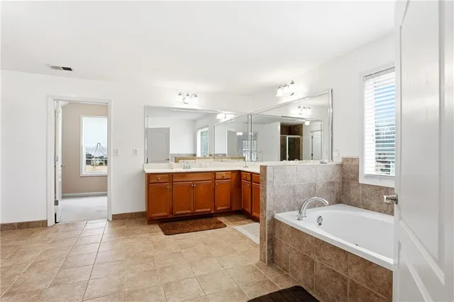 a large bathroom with a large tub shower and sink