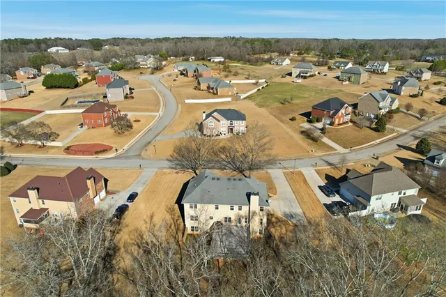 an aerial view of residential houses with outdoor space