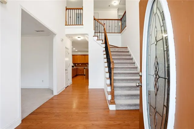 a view of entryway and hall with wooden floor