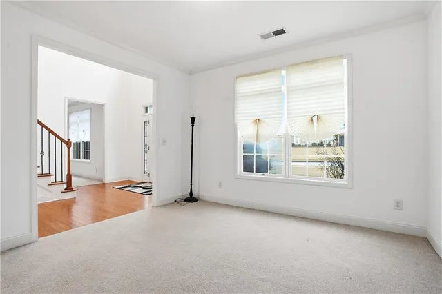 an empty room with a empty space and windows