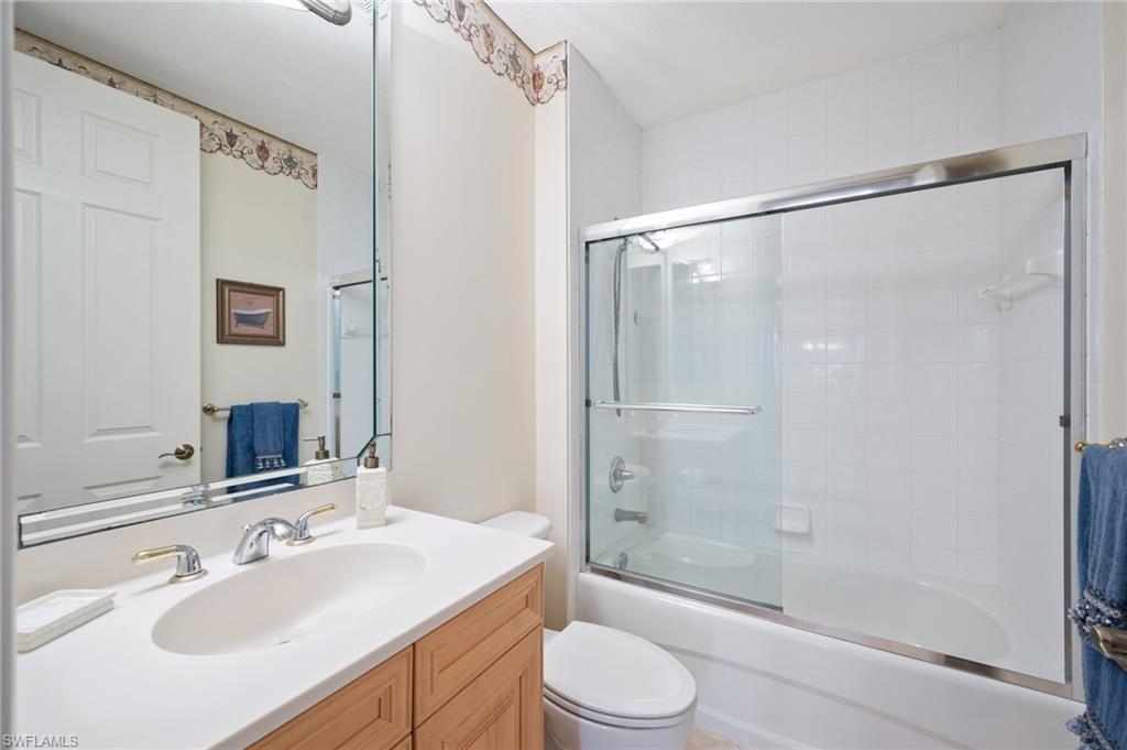 722 Regency Reserve Circle, Unit 3001 Naples, FL 34119 - Photo 14 of 22 a bathroom with a sink mirror shower and a toilet
