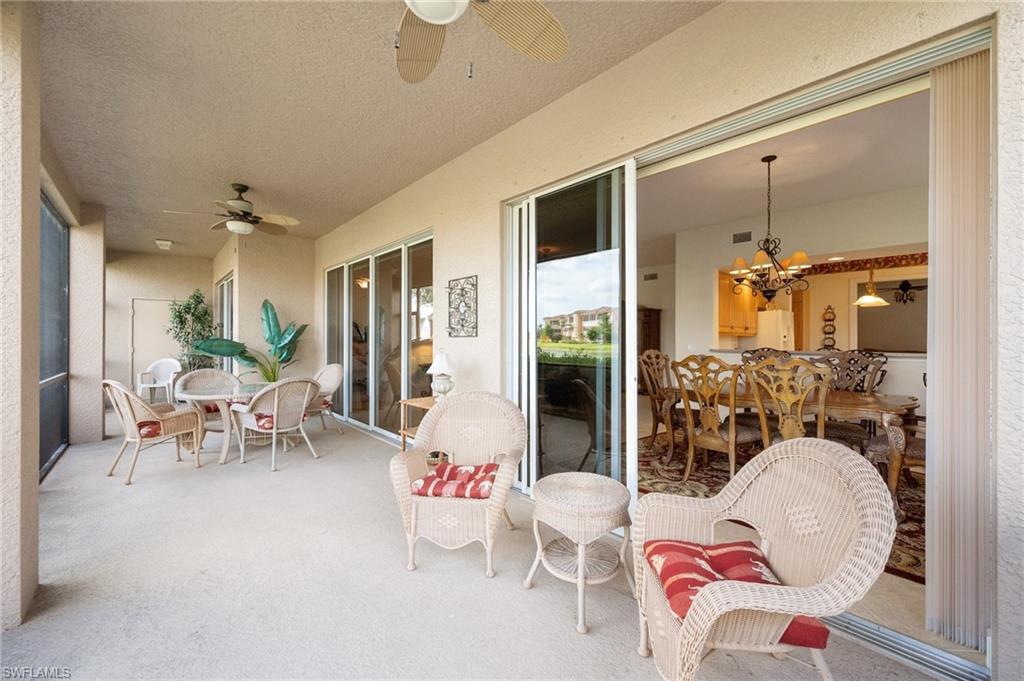 722 Regency Reserve Circle, Unit 3001 Naples, FL 34119 - Photo 15 of 22 a living room with furniture and a large window