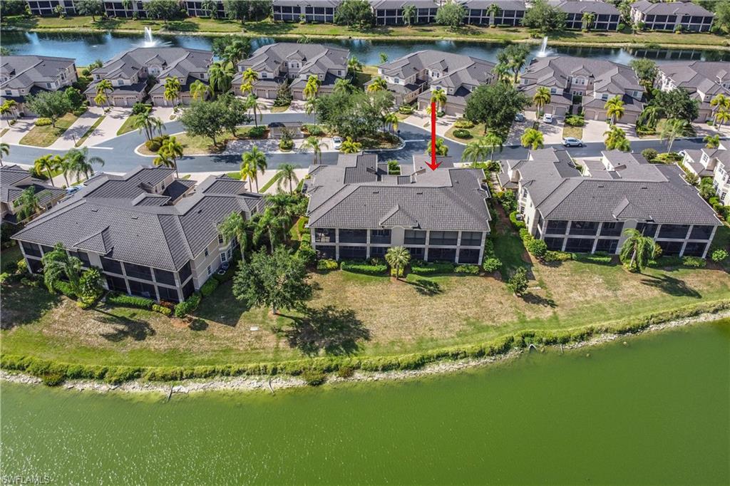 722 Regency Reserve Circle, Unit 3001 Naples, FL 34119 - Photo 21 of 22 a view of a lake with a house