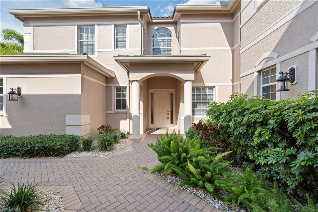 722 Regency Reserve Circle, Unit 3001 Naples, FL 34119 - Photo 22 of 22 a front view of a house with garden
