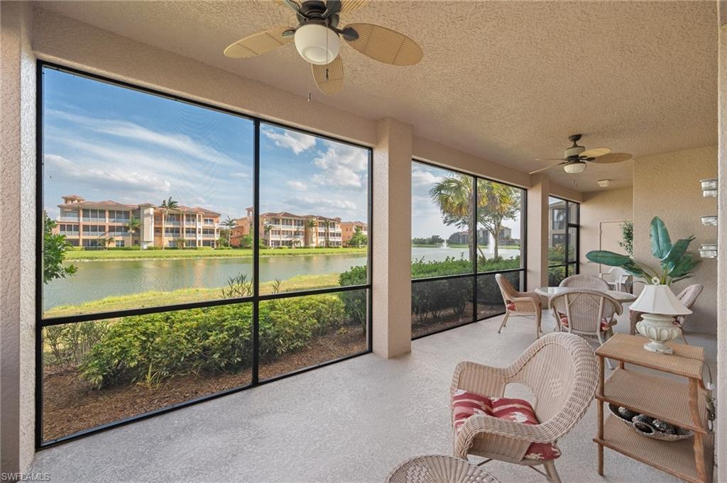 722 Regency Reserve Circle, Unit 3001 Naples, FL 34119 - Photo 3 of 22 a living room with furniture and a floor to ceiling window
