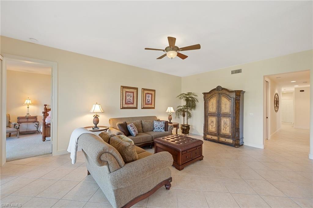722 Regency Reserve Circle, Unit 3001 Naples, FL 34119 - Photo 5 of 22 a living room with furniture and a window