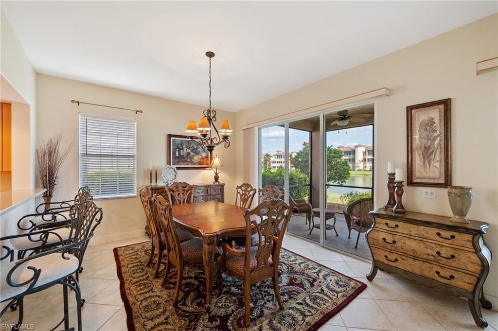 722 Regency Reserve Circle, Unit 3001 Naples, FL 34119 - Photo 8 of 22 a dining room with furniture a chandelier and wooden floor