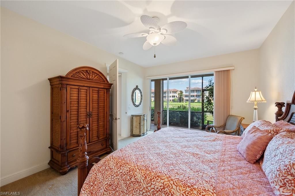722 Regency Reserve Circle, Unit 3001 Naples, FL 34119 - Photo 10 of 22 a bedroom with a large bed a chandelier and dresser