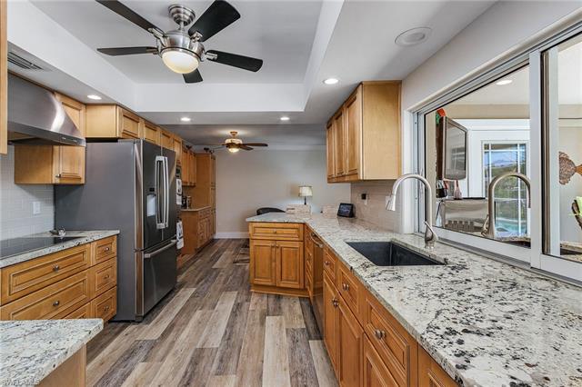 8522 Lagoon Road Fort Myers Beach, FL 33931 - Photo 2 of 32 Recently remodeled kitchen, soft close and pull out drawers, stainless steel appliances, slider window to serve guests enjoying the pool deck.