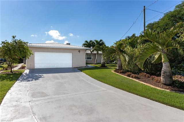 8522 Lagoon Road Fort Myers Beach, FL 33931 - Photo 22 of 32 Bring your family and friends, extra deep 4 car garage or workshop, long driveway for extra parking, Beautiful tropical landscape.