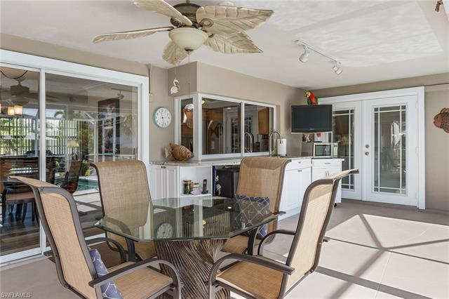 8522 Lagoon Road Fort Myers Beach, FL 33931 - Photo 28 of 32 Pool deck perfect for entertaining, equipped with wet bar, T.V, microwave, mini-fridge, wine cooler and plenty of sitting space.