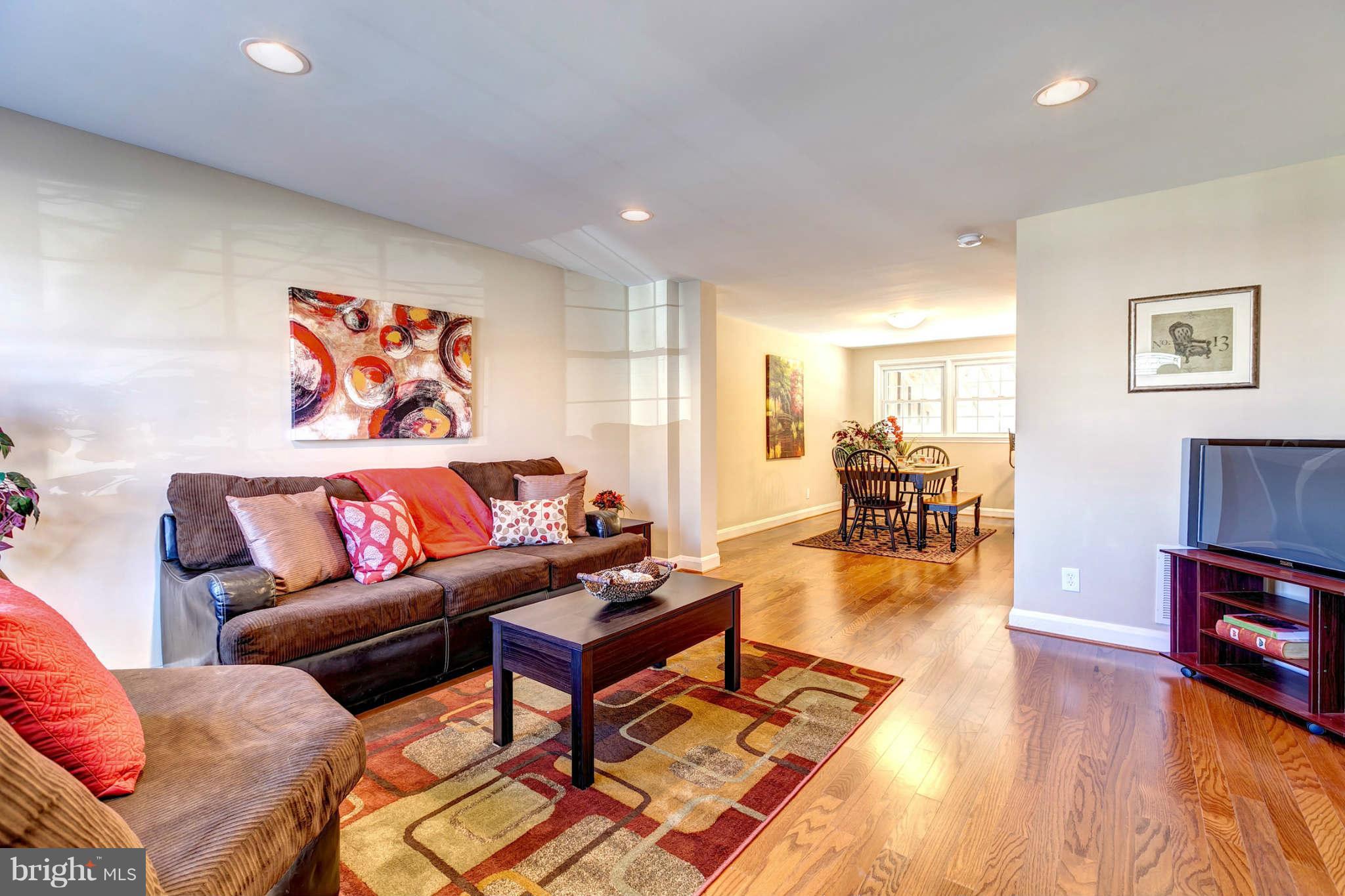 1403 Clairidge Road Baltimore, MD 21207 - Photo 1 of 29 a living room with furniture and a wooden floor