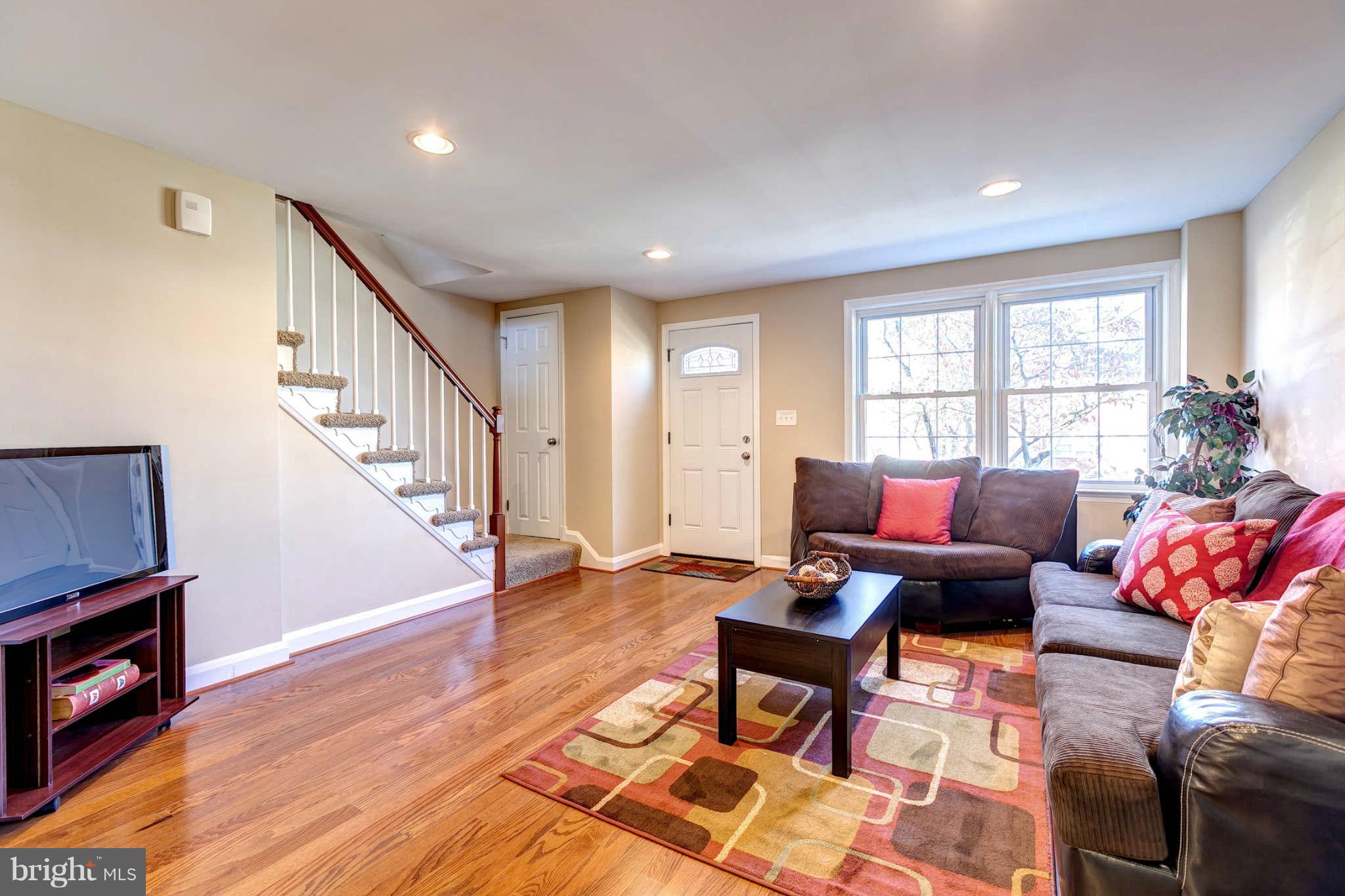 1403 Clairidge Road Baltimore, MD 21207 - Photo 3 of 29 a living room with furniture and wooden floor