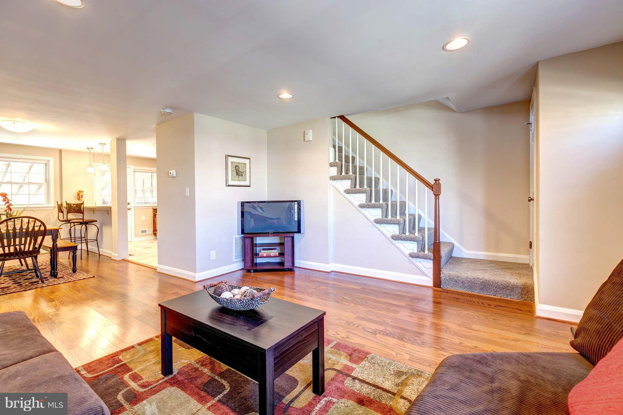 1403 Clairidge Road Baltimore, MD 21207 - Photo 4 of 29 a living room with furniture and a table with wooden floor