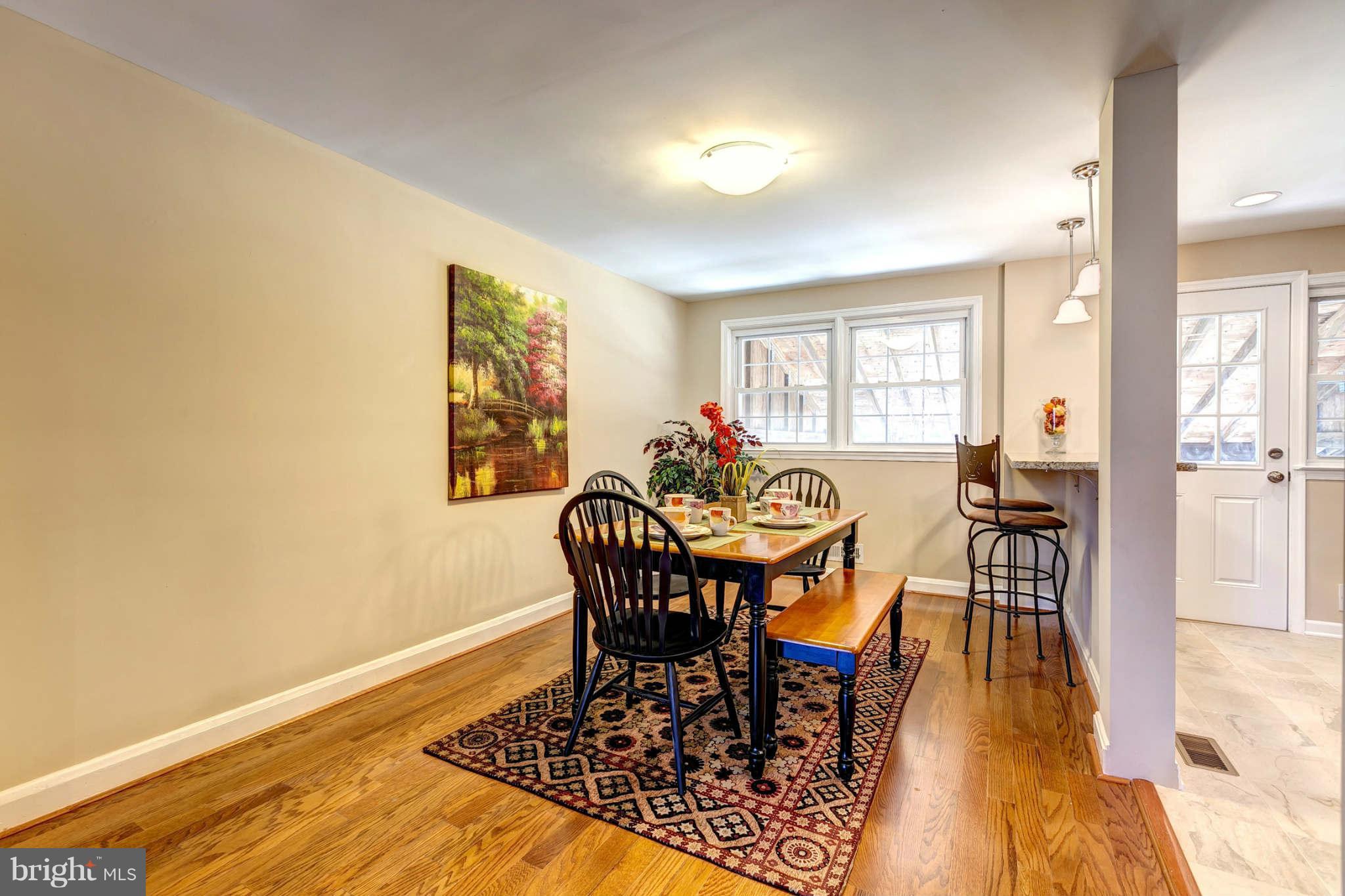 1403 Clairidge Road Baltimore, MD 21207 - Photo 5 of 29 a view of a dining room with furniture window and wooden floor
