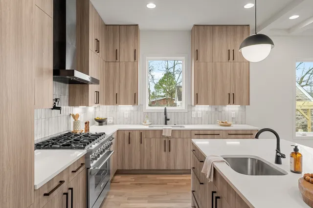 a kitchen with a sink stove and cabinets