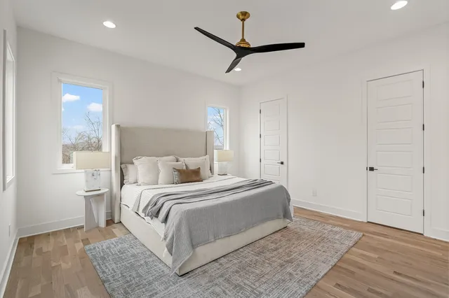 a bedroom with a large bed and a ceiling fan