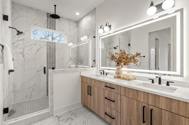a bathroom with a shower sink double and mirror