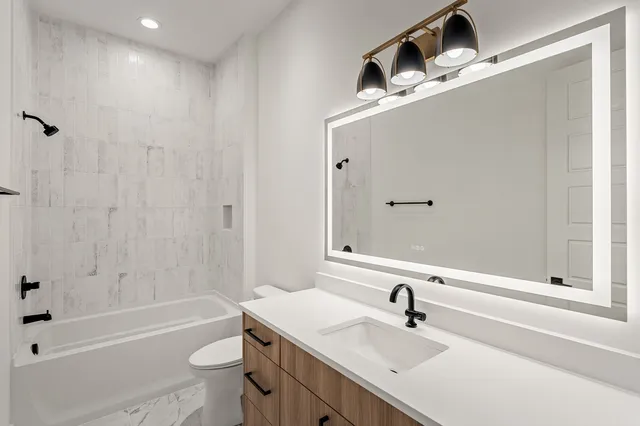 a bathroom with a sink a toilet and a bathtub