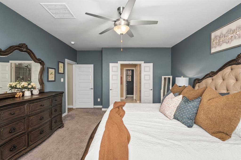 4017 Mapleleaf Pass Melissa, TX 75454 - Photo 13 of 32 a spacious bedroom with a large bed and a chandelier