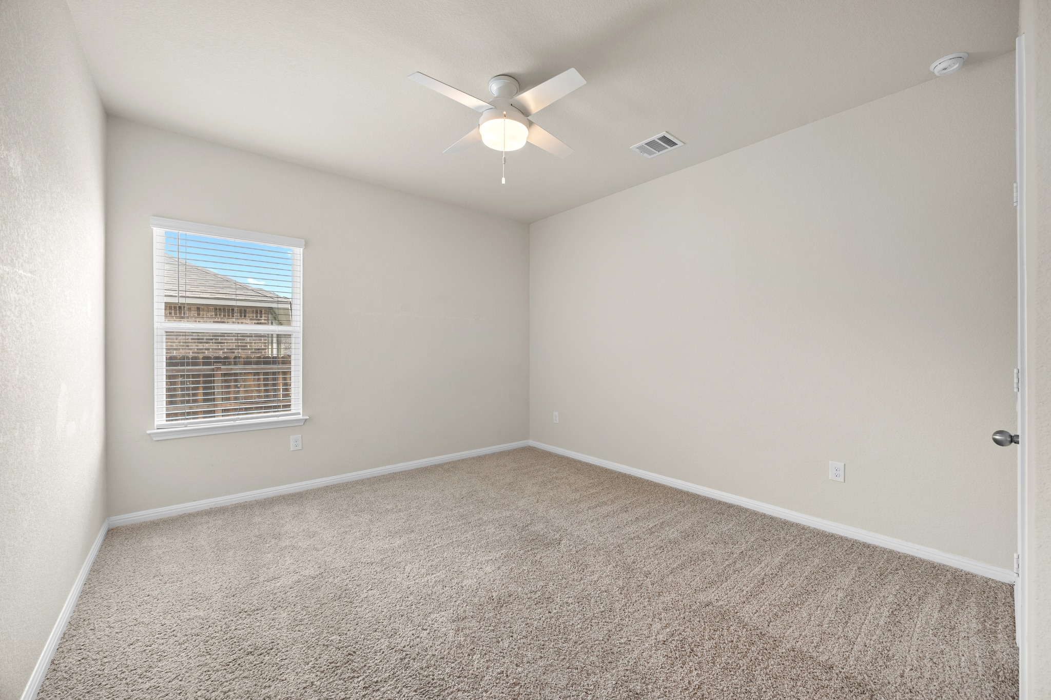 2413 Starhill Ranch Street Georgetown, TX 78628 - Photo 24 of 40 an empty room with a window and a ceiling fan