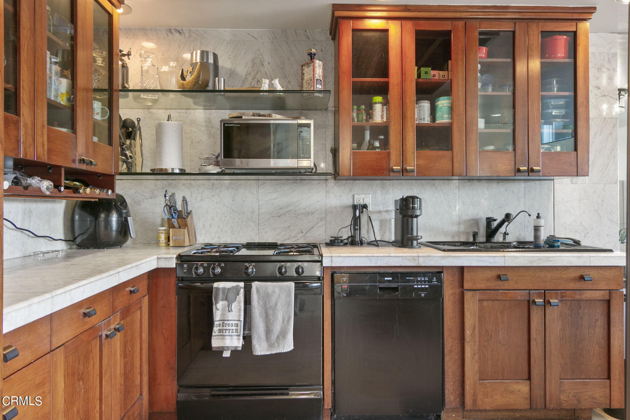 3334 Sunset Lane Oxnard, CA 93035 - Photo 13 of 37 a kitchen with stainless steel appliances granite countertop a stove and a microwave