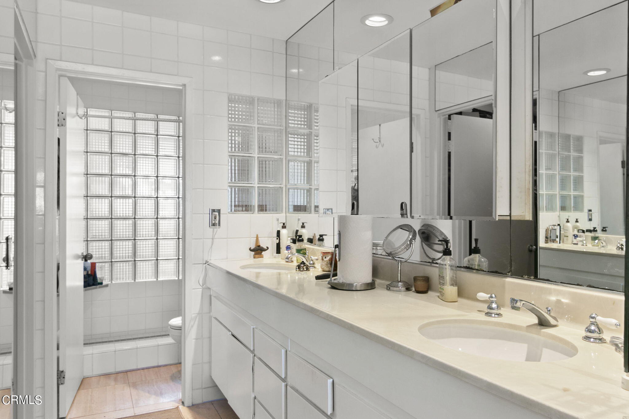 3334 Sunset Lane Oxnard, CA 93035 - Photo 22 of 37 a bathroom with double vanity sinks and a mirror