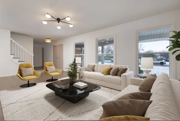 a living room with furniture a lamp and a large window