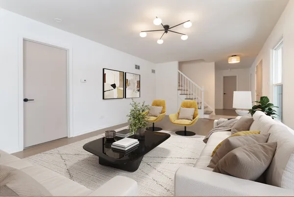 a living room with furniture and a potted plant
