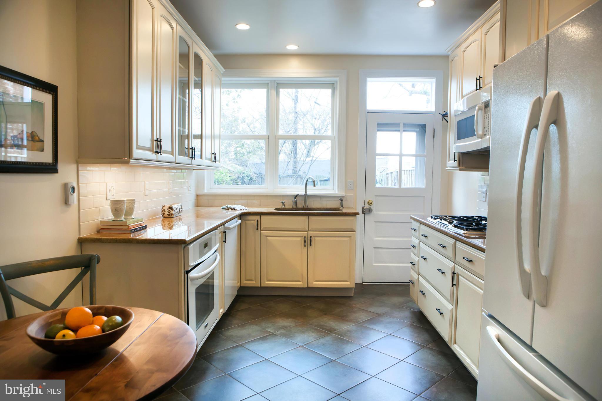 917 E Street Southeast Washington, DC 20003 - Photo 12 of 30 a kitchen with stainless steel appliances a stove a sink and a refrigerator