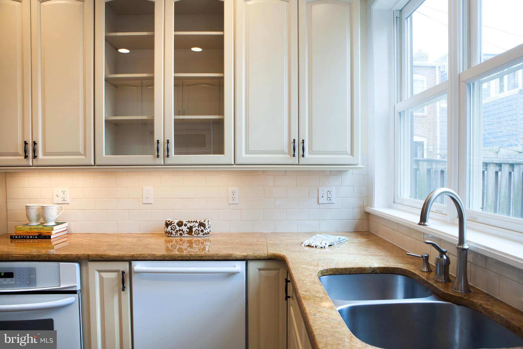 917 E Street Southeast Washington, DC 20003 - Photo 15 of 30 a kitchen with stainless steel appliances granite countertop a sink and cabinets with wooden floor