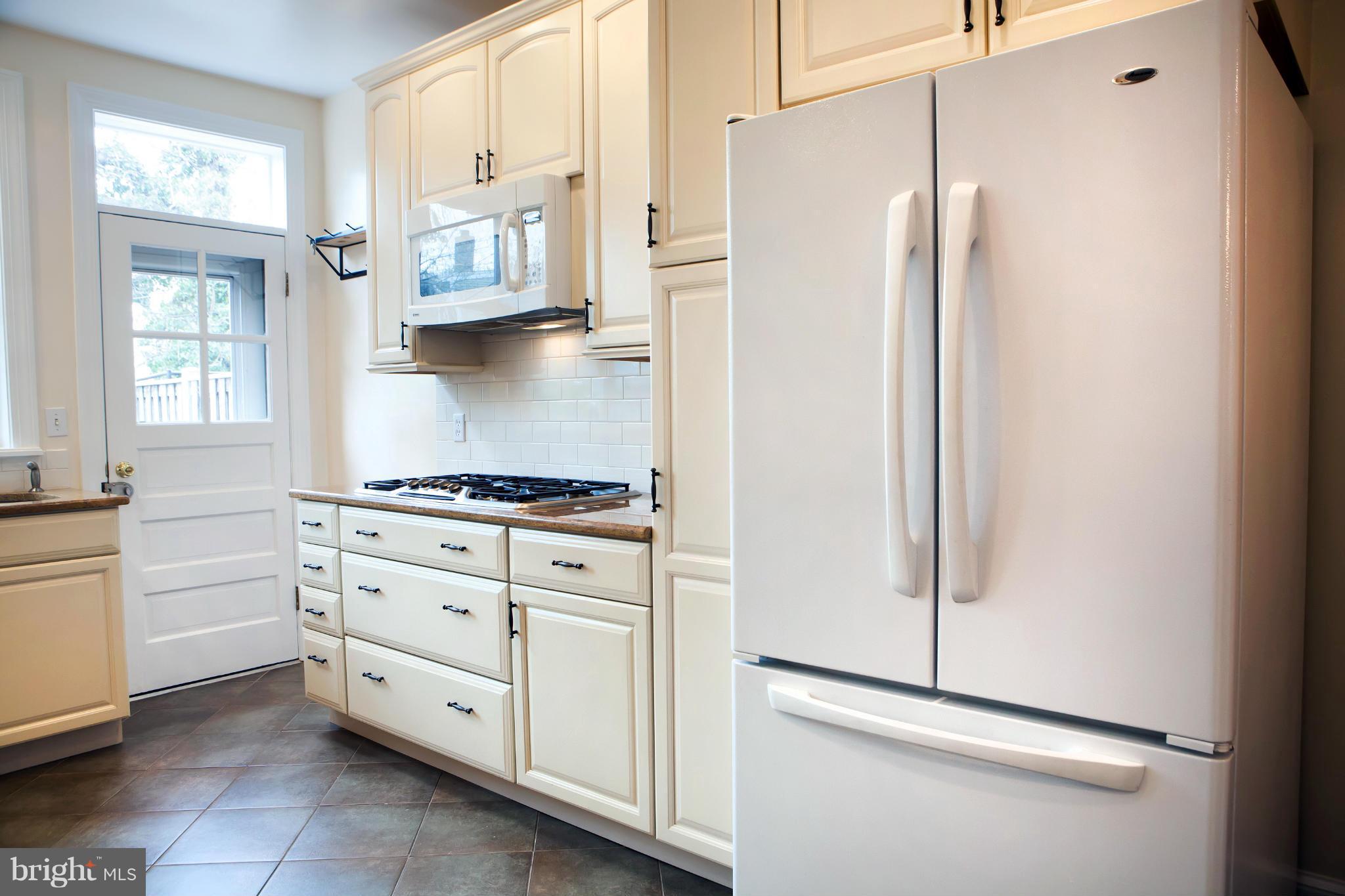 917 E Street Southeast Washington, DC 20003 - Photo 16 of 30 a kitchen with stainless steel appliances a refrigerator and white cabinets