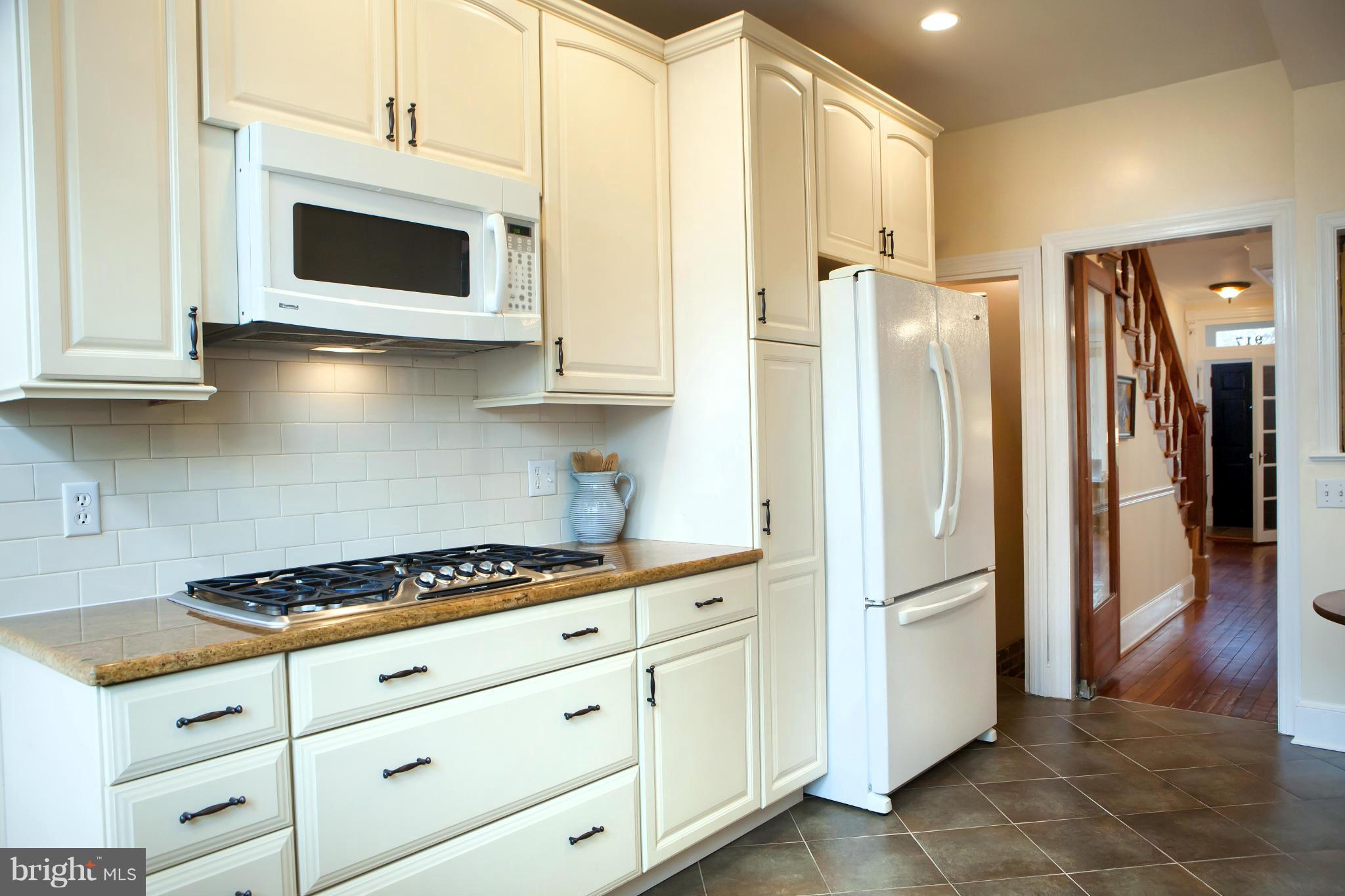 917 E Street Southeast Washington, DC 20003 - Photo 17 of 30 a kitchen with stainless steel appliances white cabinets and a stove top oven