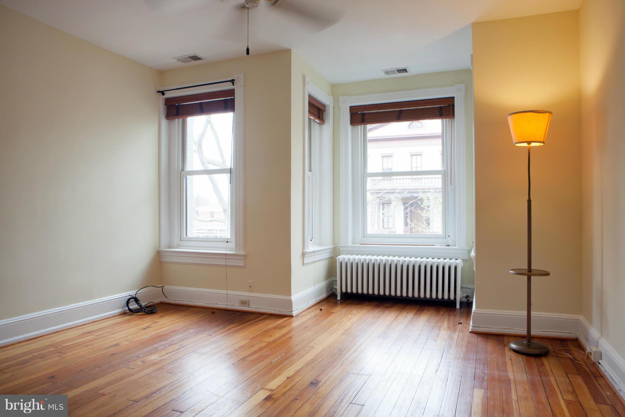 917 E Street Southeast Washington, DC 20003 - Photo 21 of 30 an empty room with wooden floor and windows