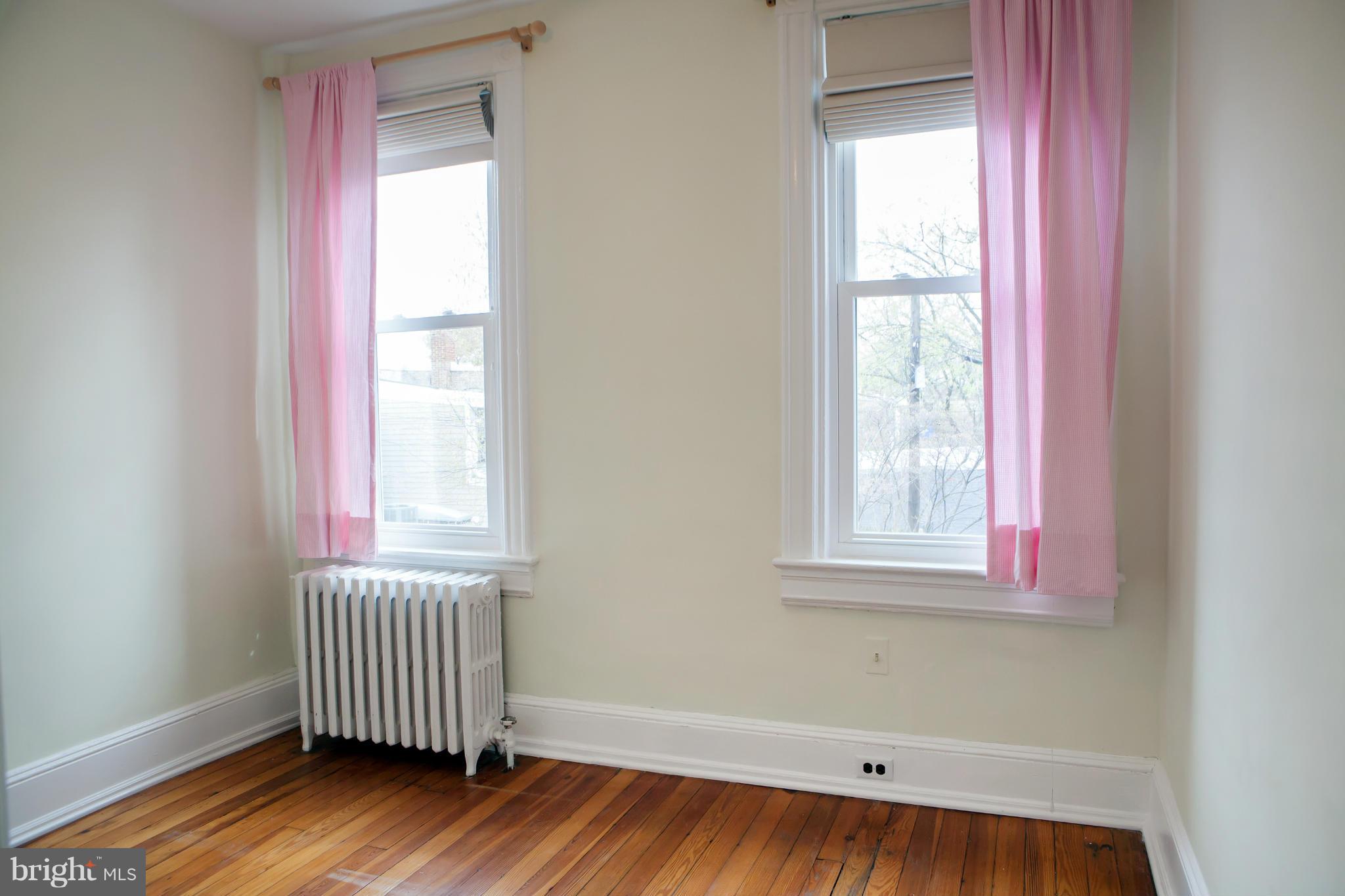 917 E Street Southeast Washington, DC 20003 - Photo 26 of 30 an empty room with wooden floor and windows