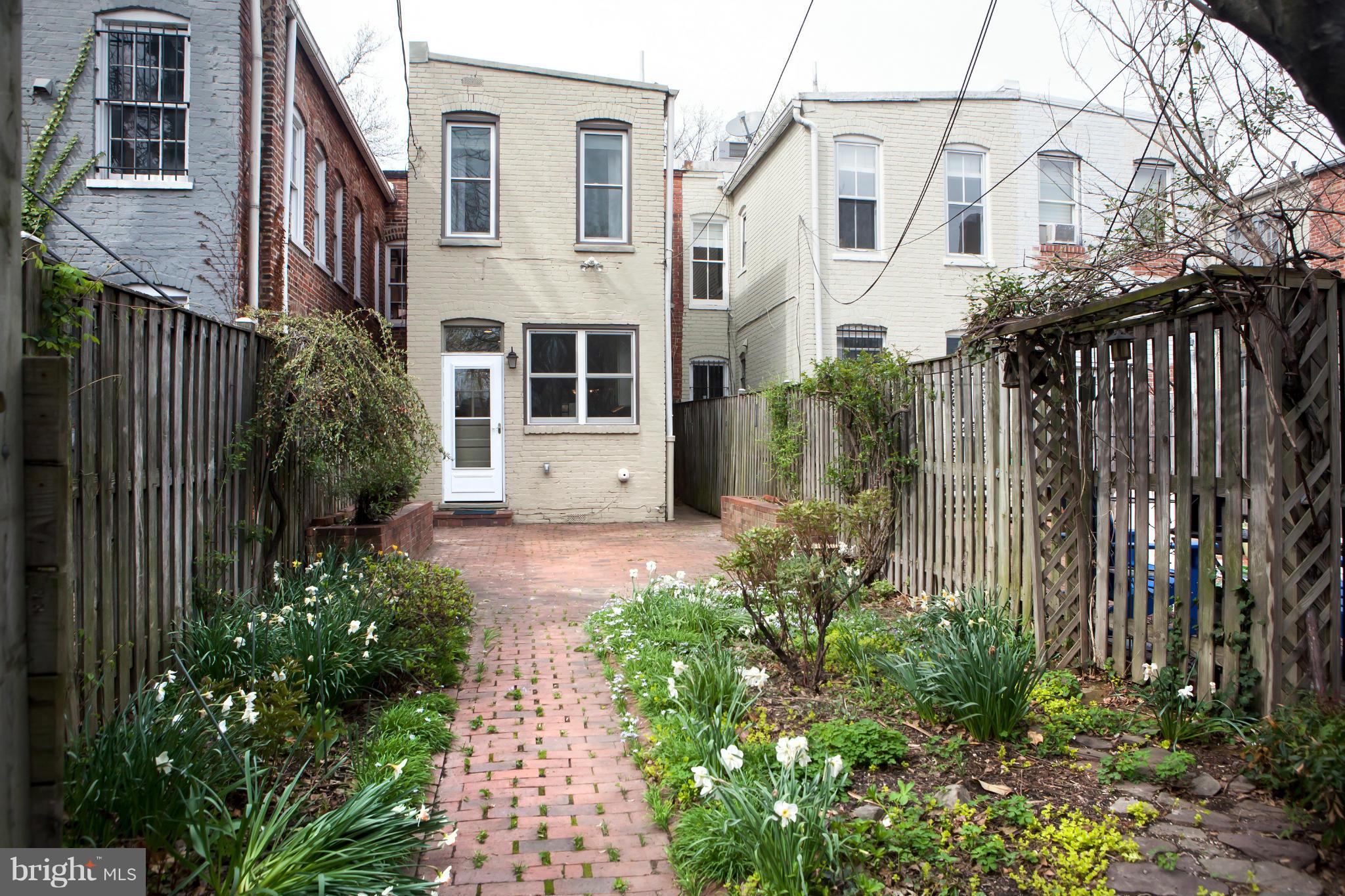 917 E Street Southeast Washington, DC 20003 - Photo 30 of 30 a view of a white house with a large windows and flower plants