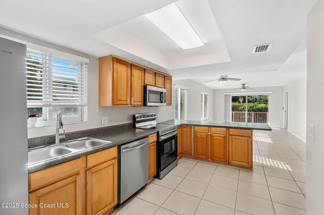 a kitchen with granite countertop a sink stove and cabinets