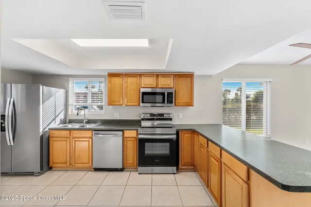 a kitchen with stainless steel appliances granite countertop a stove sink and refrigerator