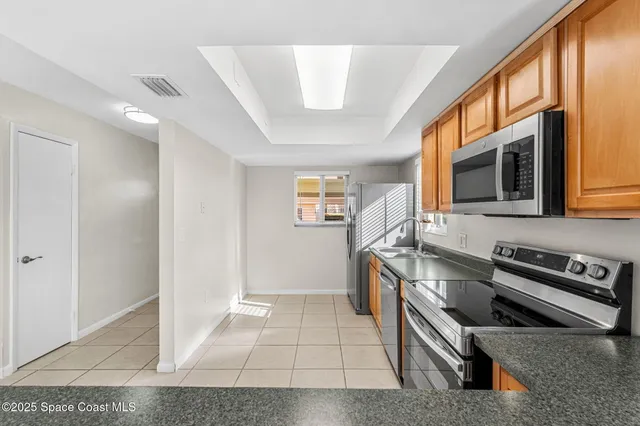 a kitchen with stainless steel appliances granite countertop a stove and a microwave