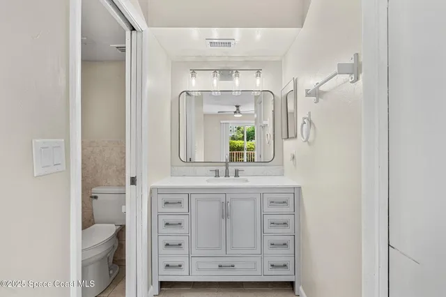 a bathroom with a granite countertop sink a mirror and a bathtub