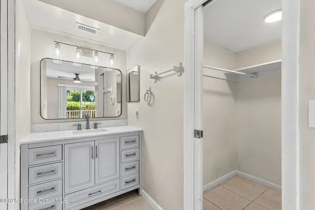 a bathroom with a double vanity sink and mirror