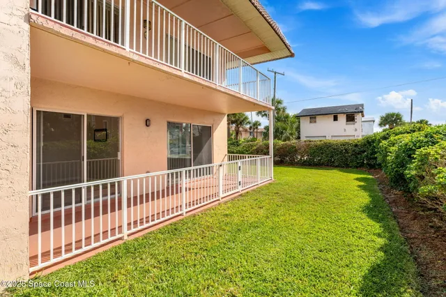 a view of a house with a backyard