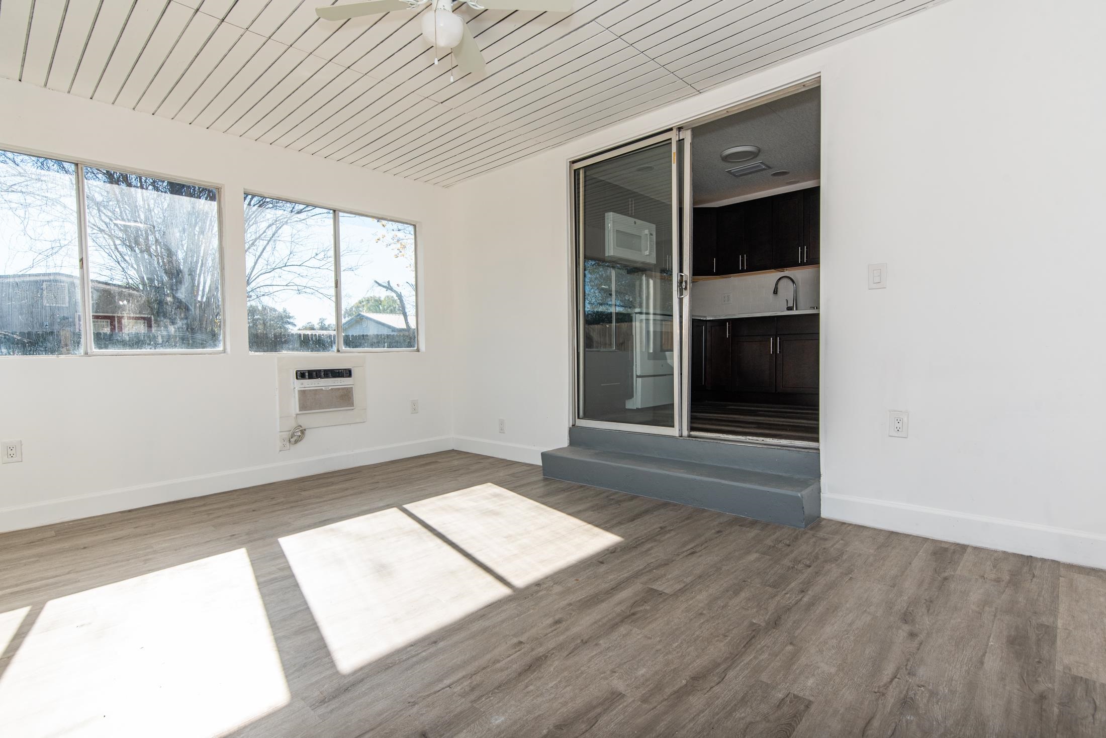 905 Palermo Road St. Augustine, FL 32086 - Photo 11 of 30 an empty room with wooden floor and windows