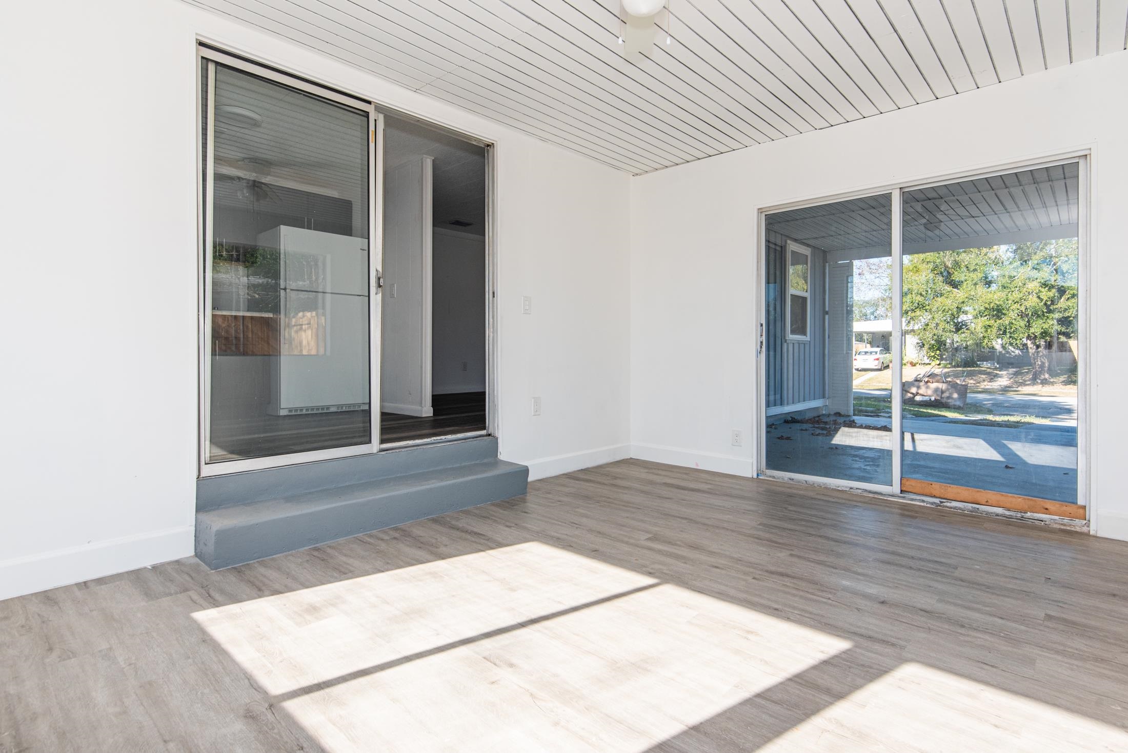 905 Palermo Road St. Augustine, FL 32086 - Photo 12 of 30 an empty room with wooden floor and windows