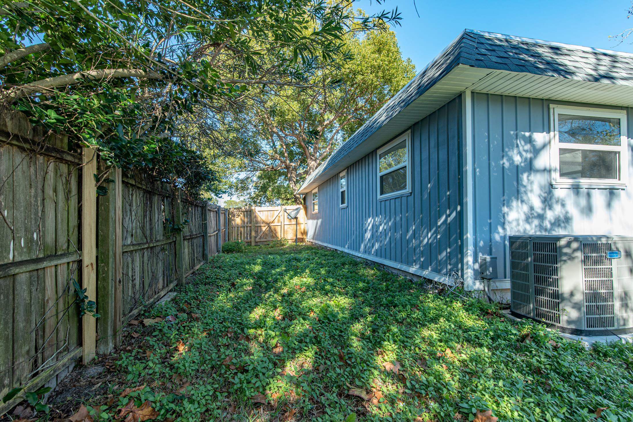 905 Palermo Road St. Augustine, FL 32086 - Photo 23 of 30 a view of a wooden house with a big yard and plants
