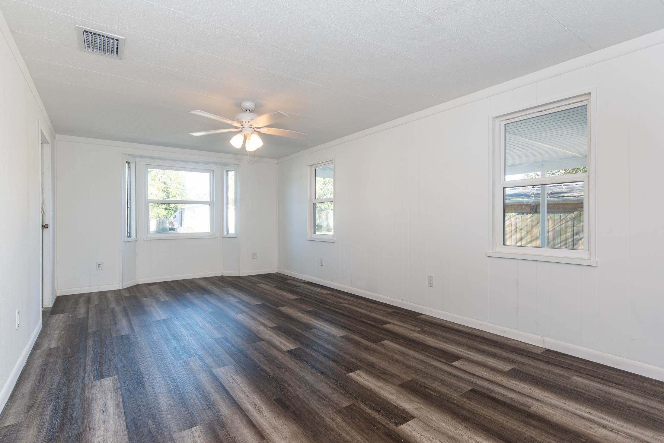 905 Palermo Road St. Augustine, FL 32086 - Photo 3 of 30 a view of an empty room with wooden floor and a window