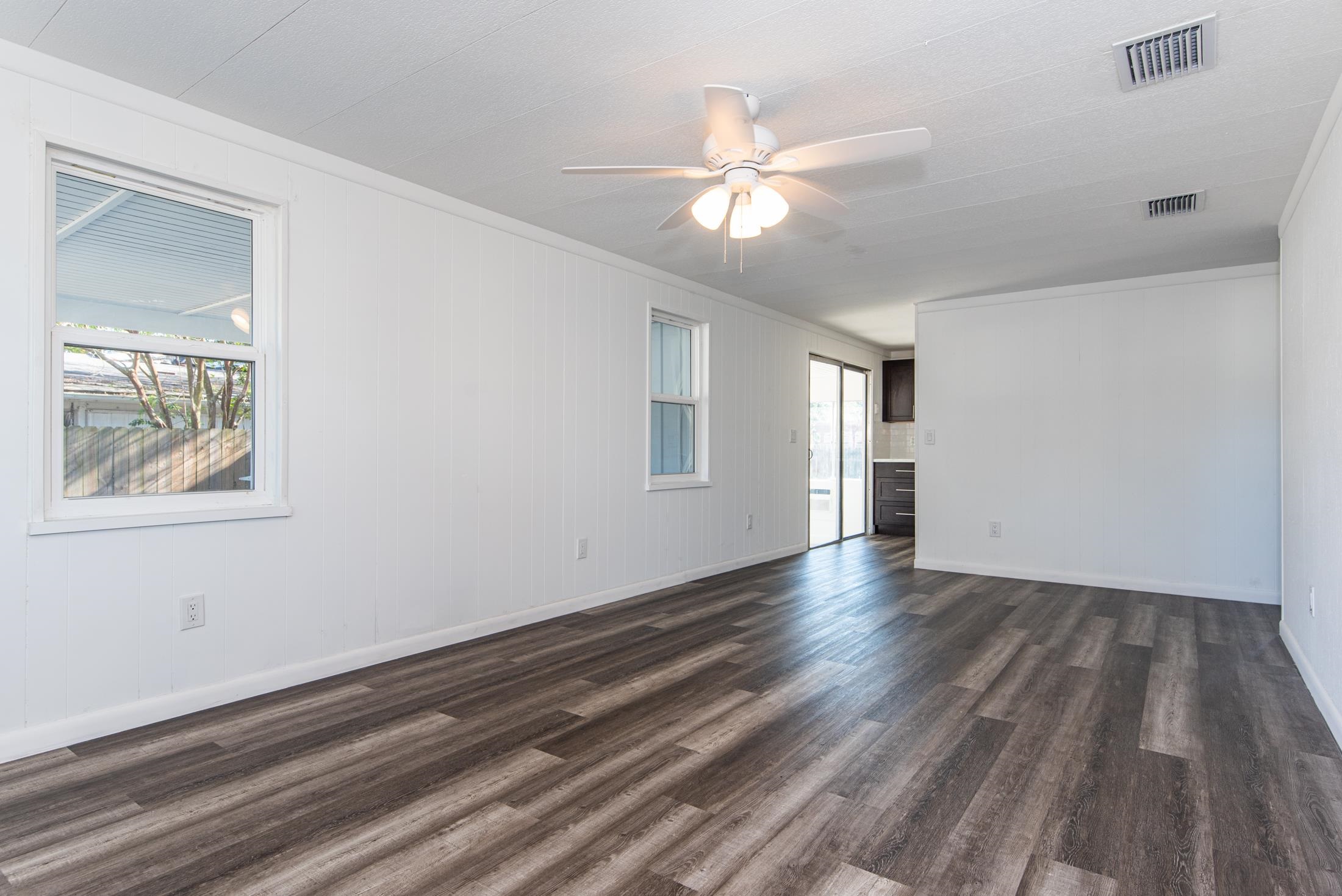 905 Palermo Road St. Augustine, FL 32086 - Photo 4 of 30 a view of an empty room with wooden floor and a window