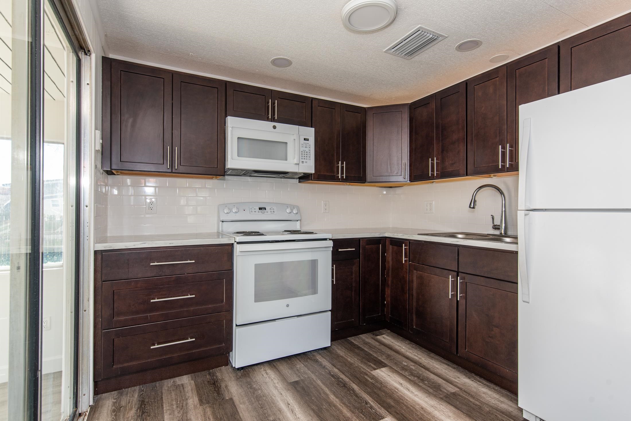 905 Palermo Road St. Augustine, FL 32086 - Photo 7 of 30 a kitchen with a sink a stove and refrigerator