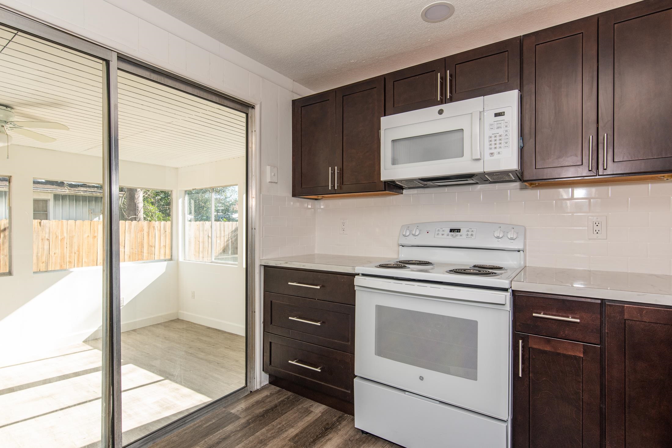 905 Palermo Road St. Augustine, FL 32086 - Photo 9 of 30 a kitchen with a stove microwave and sink