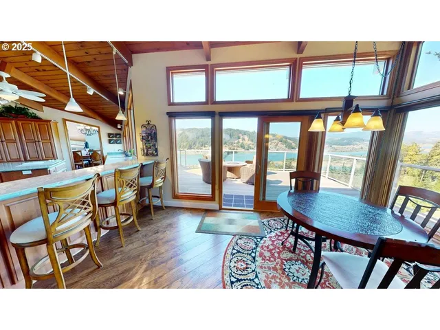 a dining room with furniture a rug and wooden floor